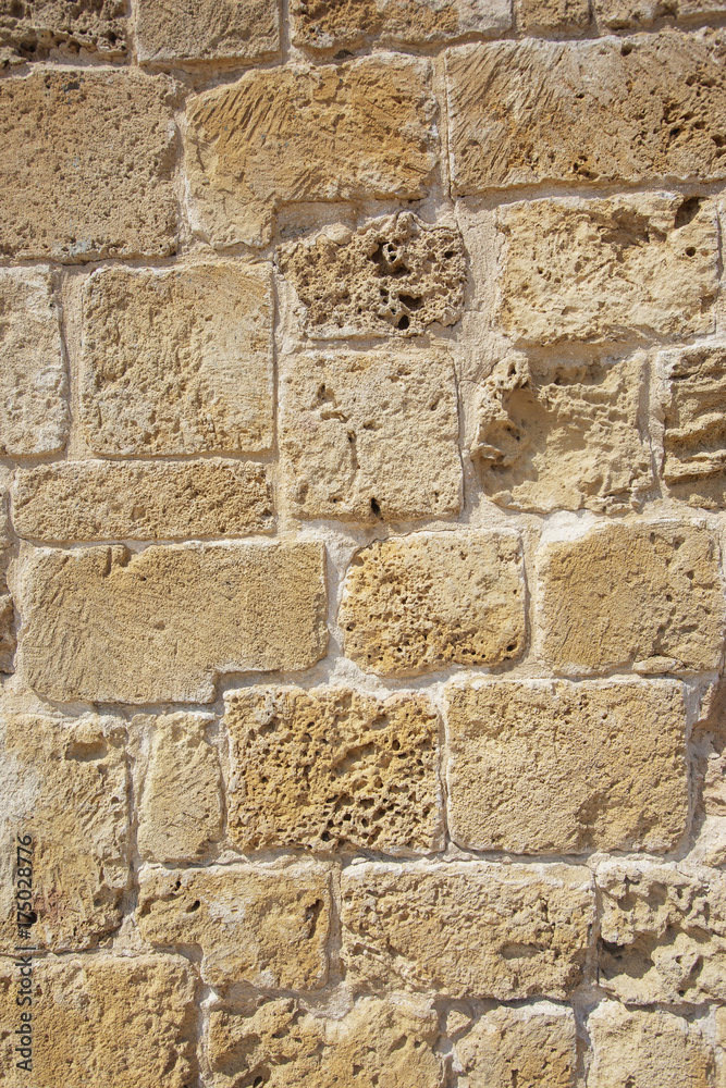 Fototapeta premium Yellow stone wall rustic background