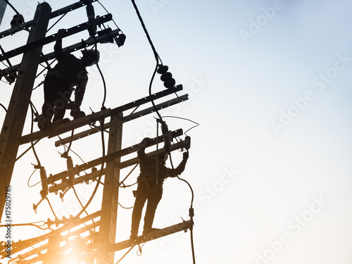 Canvas Print Electricity Power Line Lineman repair work Silhouette man working