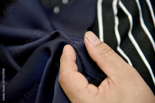 Closeup hands of Tailor man working in his cloth fabric in shop, Tailoring, close up.