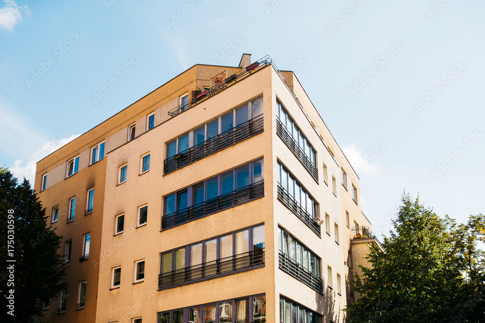 brown facaded apartment building with long windows