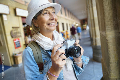 Senior woman taking pictures on tourist journey © goodluz