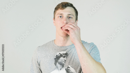 Young man chews gum. Man face, opening mouth for chewing gum, mint taste, refreshing breathe