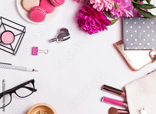 Pink flowers, macarons, feminine accessories on the white