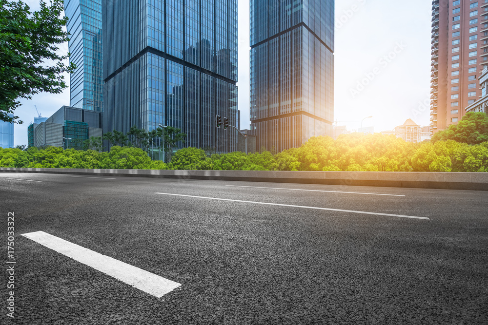 Fototapeta premium city empty traffic road with cityscape in background.