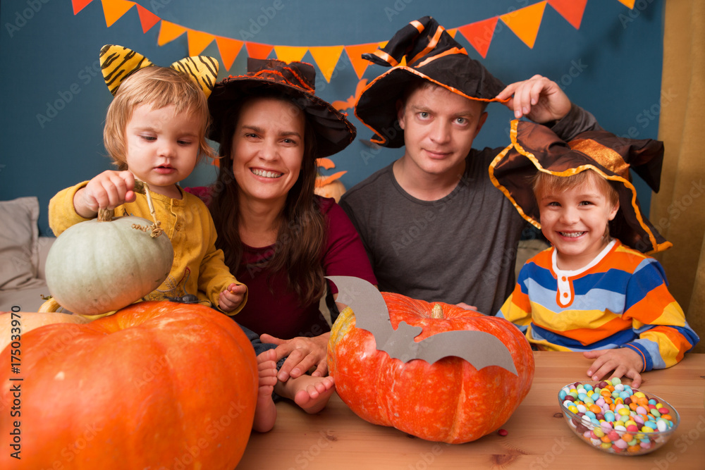 happy family mother father and two children in costumes on a celebration of Halloween happy family mother father and two children in costumes on a celebration of Halloween