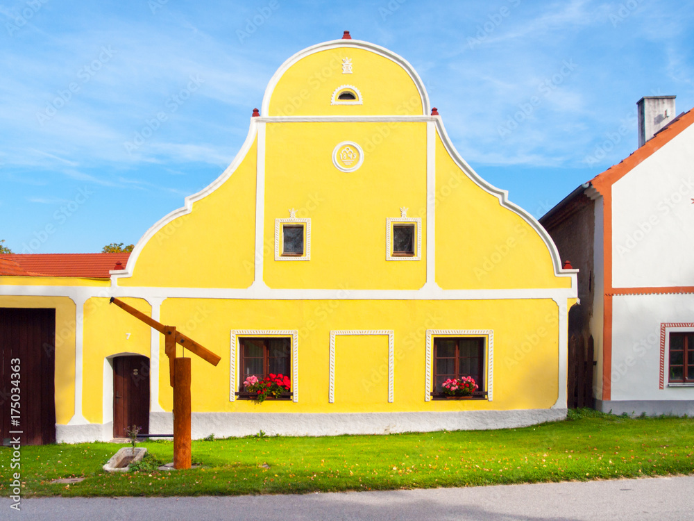 Fototapeta premium Picturesque house of Holasovice, small rural village with rustic baroque architecture. Southern Bohemia, Czech Republic. UNESCO heritage site.
