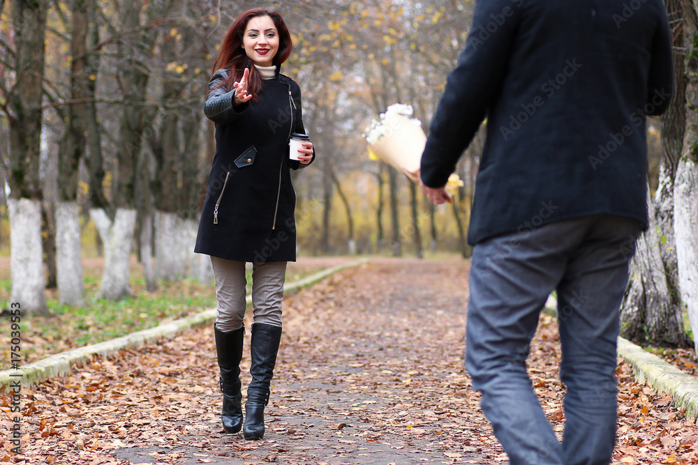 Fototapeta premium A pair of young people meets in autumn