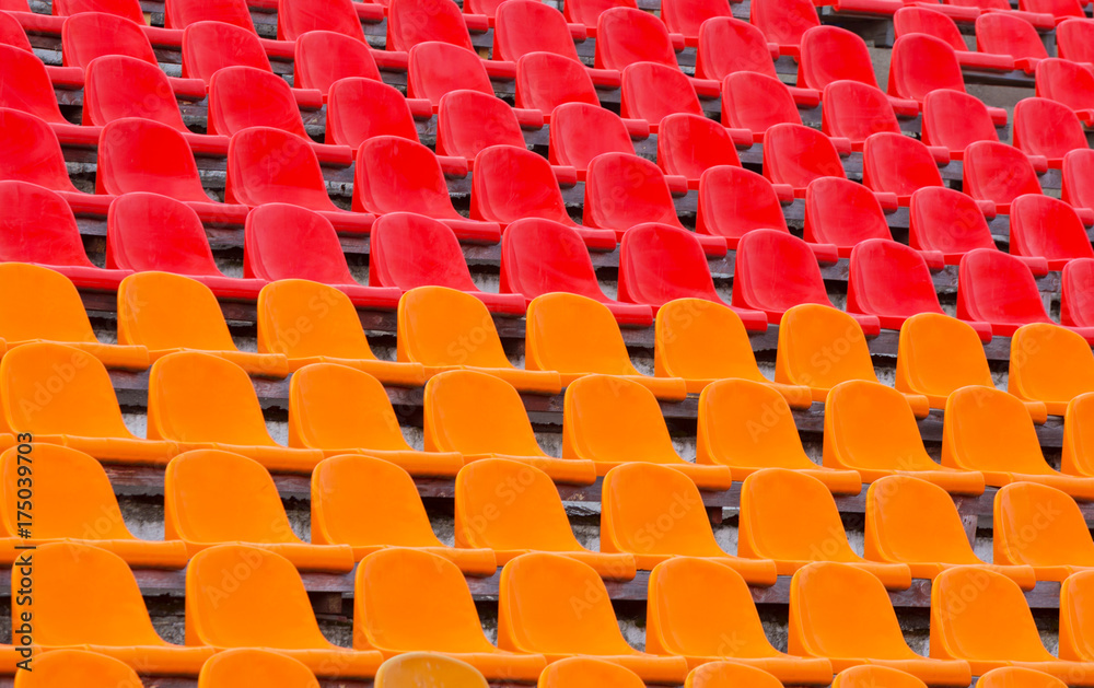 Multicolored plastic chairs in the stadium Multicolored plastic chairs in the stadium