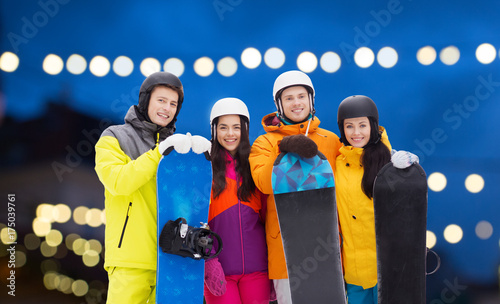 happy friends in helmets with snowboards © Syda Productions