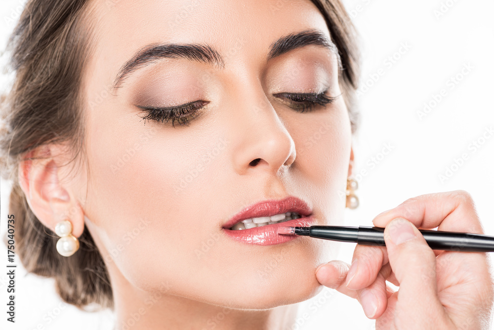 makeup artist applying lipstick on model makeup artist applying lipstick on model
