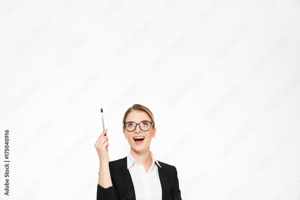 Happy blonde business woman in eyeglasses pointing and looking up Happy blonde business woman in eyeglasses pointing and looking up