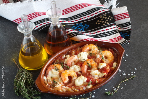 Grilled shrimps covered with feta cheese, tomatosauce photo