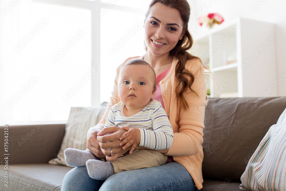 happy young mother with little baby at home