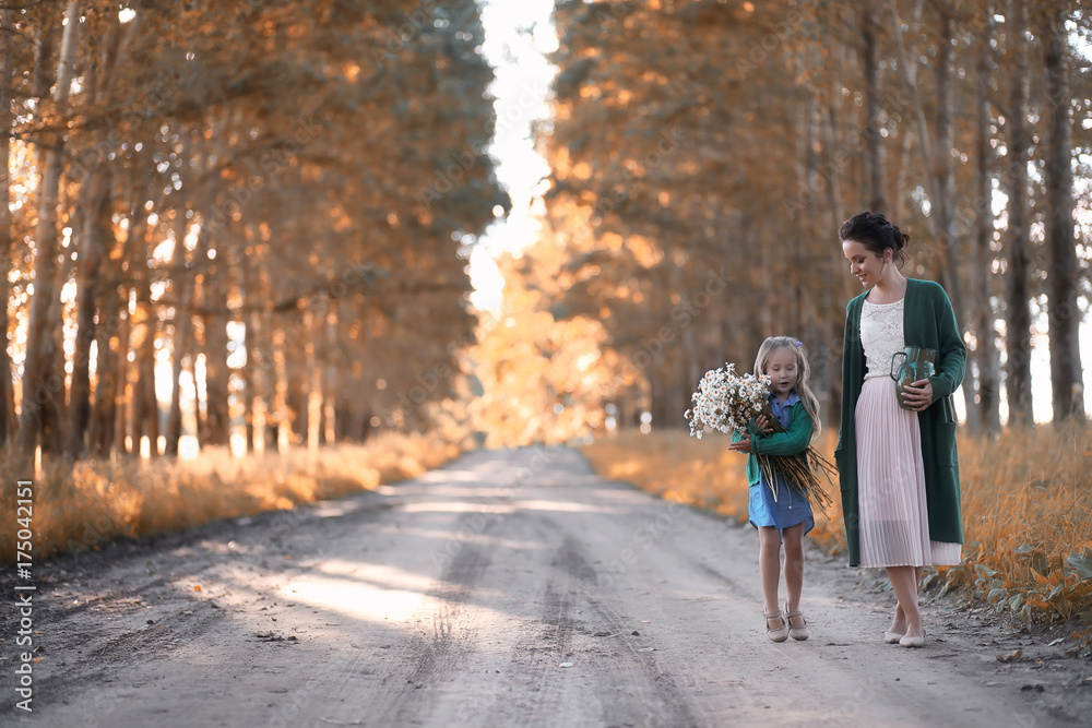 Mother with daughter walking on a road Mother with daughter walking on a road