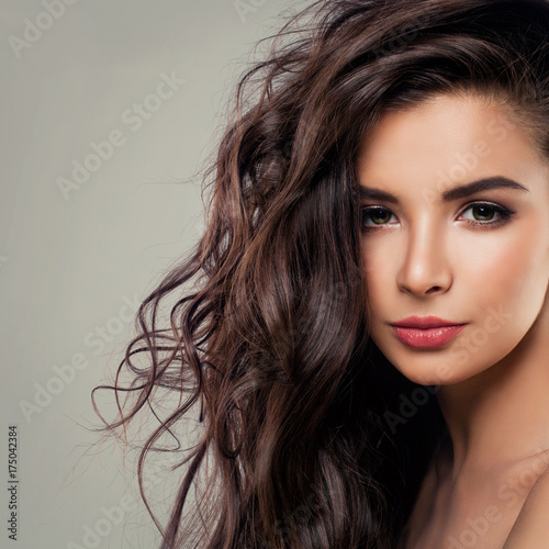 Young Brunette Woman Model with Perfect Hair and Makeup. Beautiful Female Face Closeup