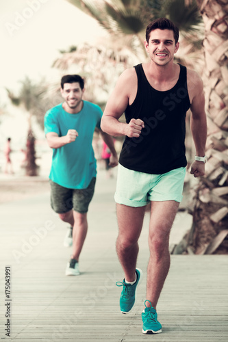 Two sportsmen jogging in park © JackF