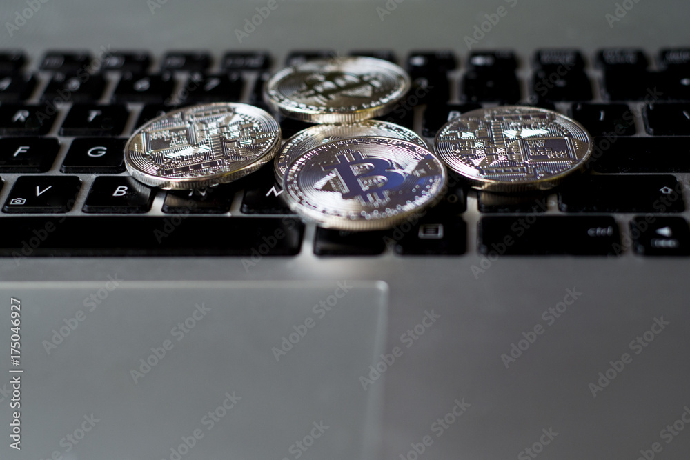 Silver bitcoin on keyboard