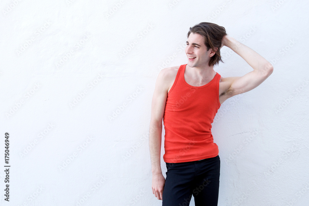 Portrait of handsome athletic man standing with hand in long hair Portrait of handsome athletic man standing with hand in long hair