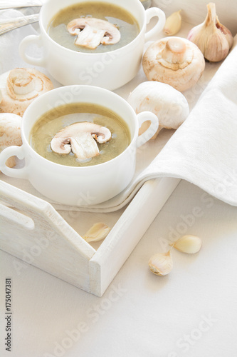 Two bowl with traditional mushroom soup cream on white table cloth