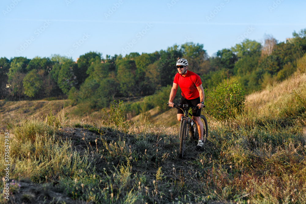 Bike adventure travel photo. Cyclist on the Beautiful Meadow Trail on sunny day.