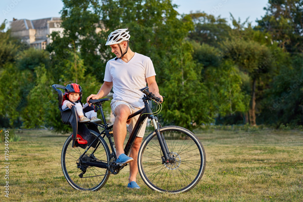 Cheerful family biking in park