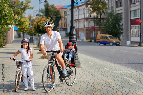 Cheerful family biking in park