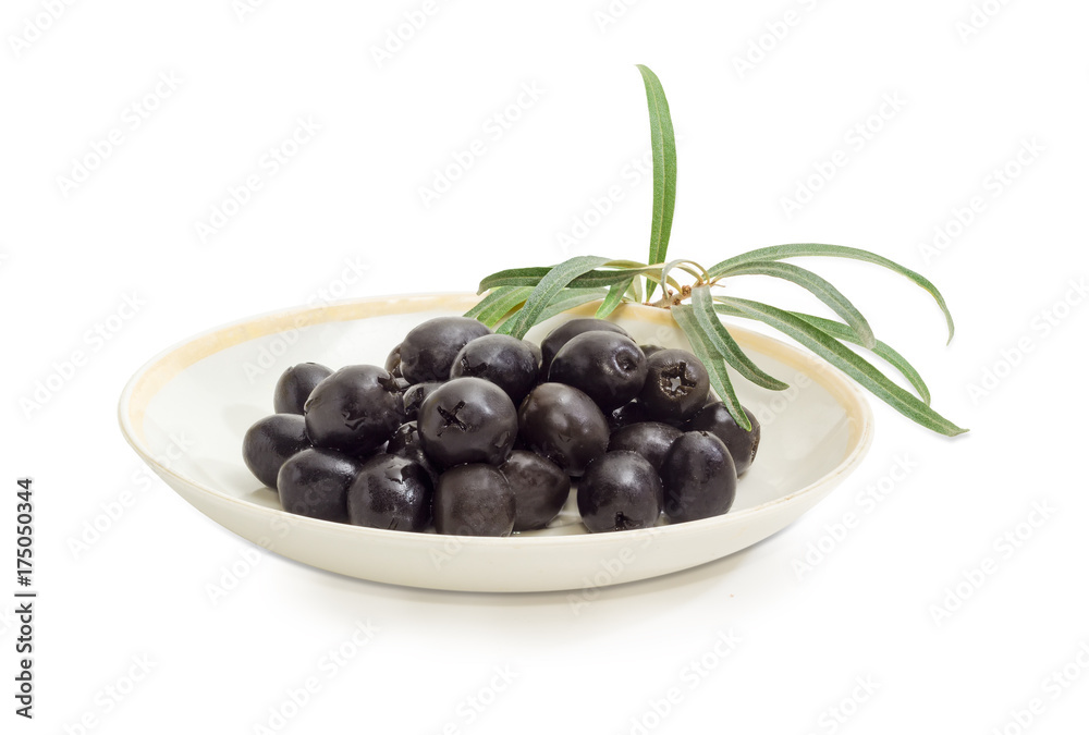 Black olives on saucer and olive branch closeup Black olives on saucer and olive branch closeup