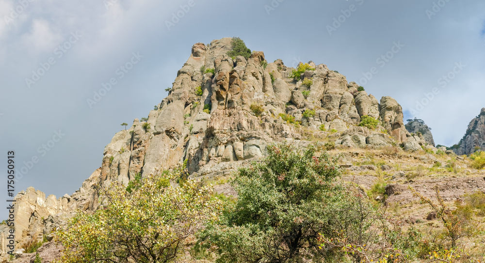 Panorama of the hillside with weathered rocks