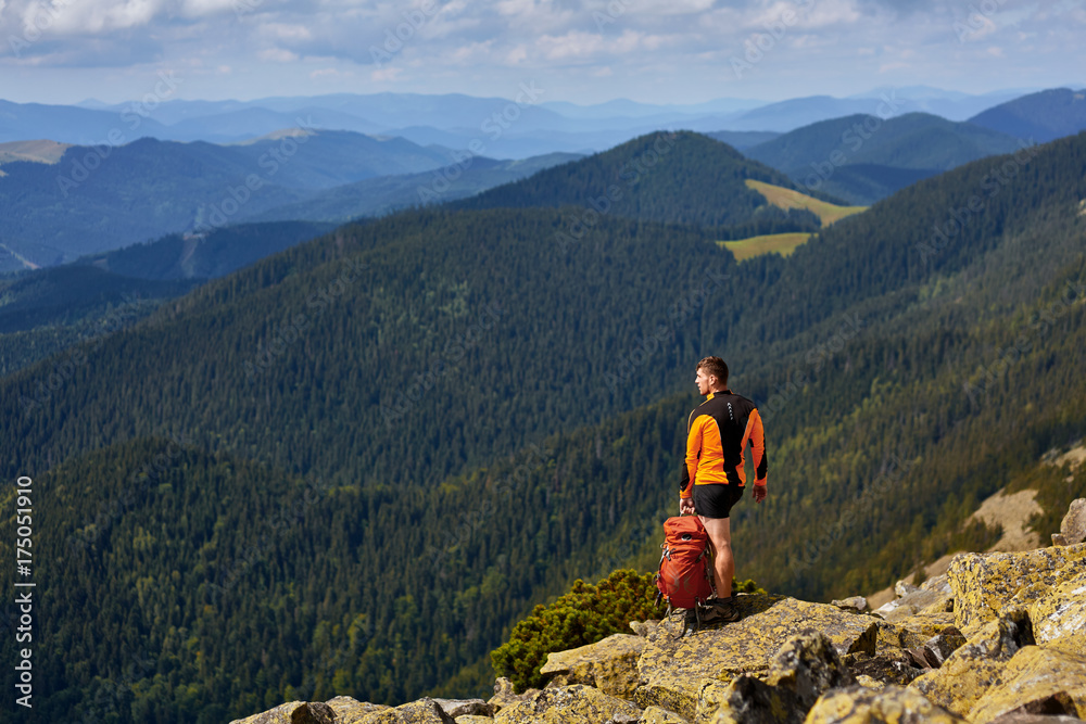 Fototapeta premium Male traveler from back in the mountains