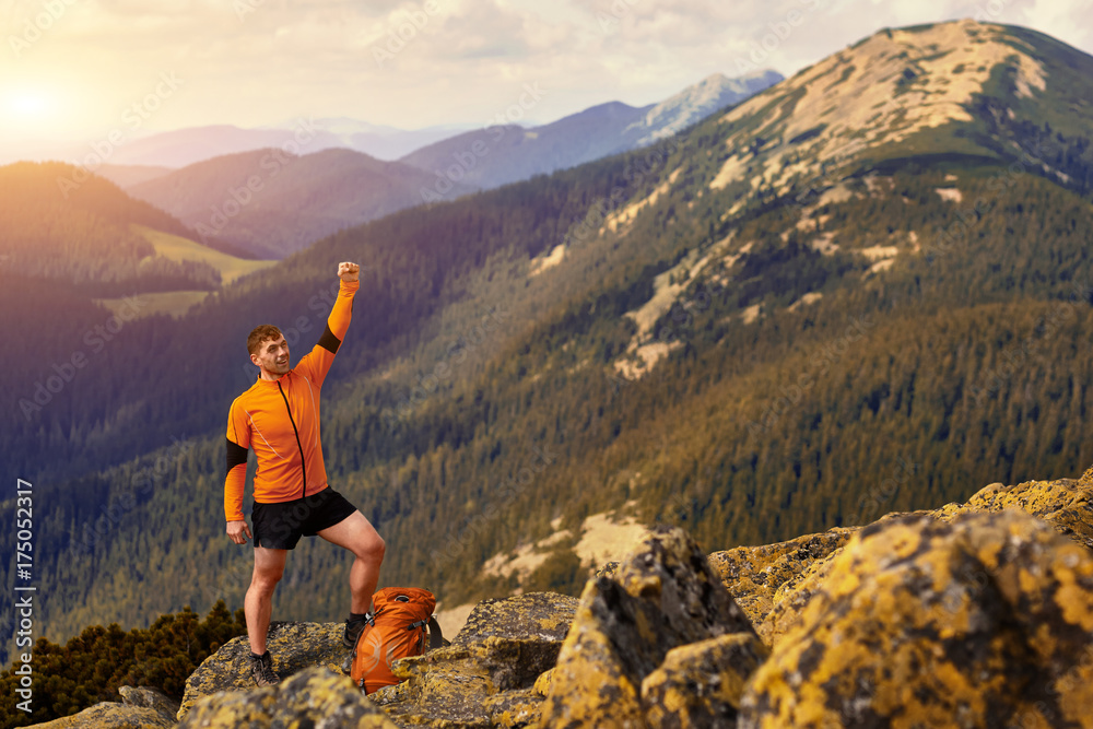 Happy hiker winning reaching life goal, success, freedom and happiness, achievement in mountains.