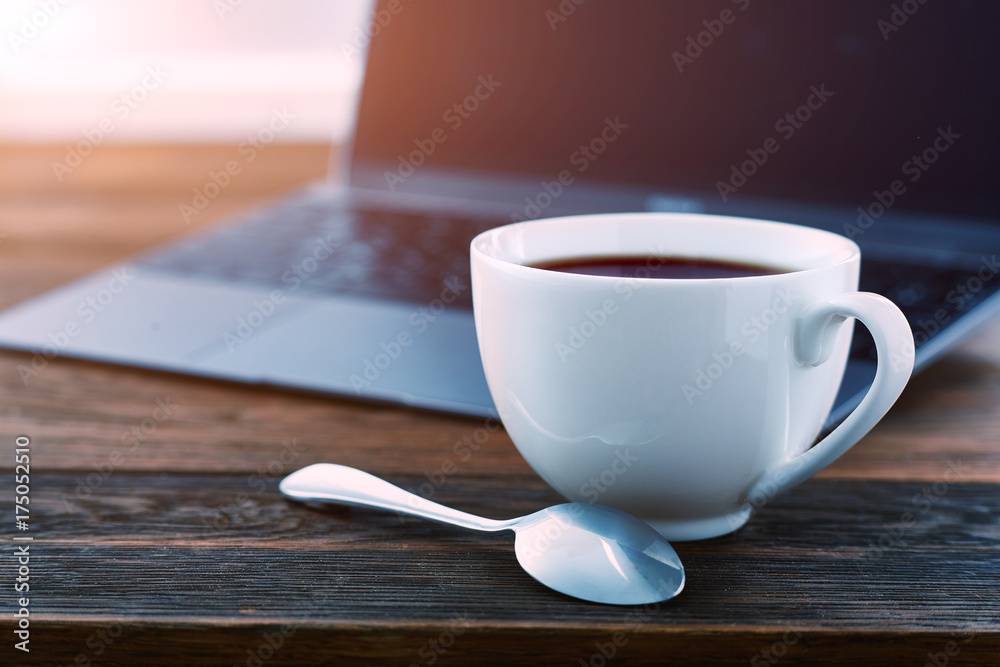 Laptop and cup of tea on rustic wooden table. Laptop and cup of tea on rustic wooden table.