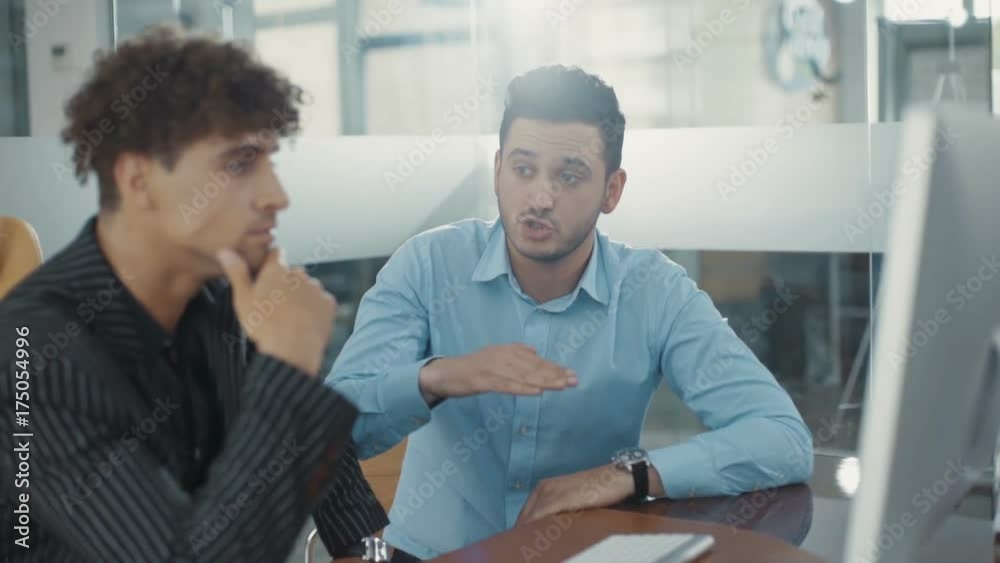 Business partners are discussing. Use computer. Speak in a modern office. Shot on RED Epic Camera. Shot on RED Epic Camera. Business partners are discussing. Use computer. Speak in a modern office. Shot on RED Epic Camera. Shot on RED Epic Camera.