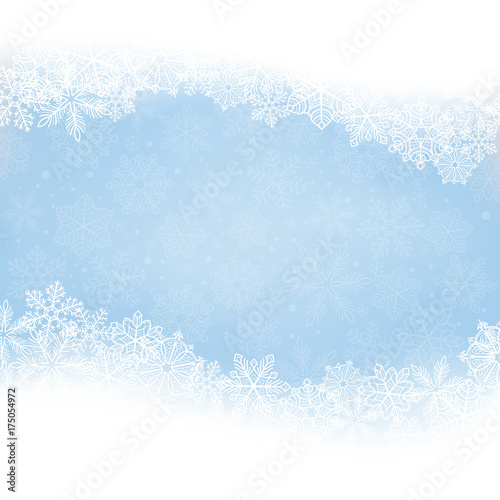Winter background. Borders made of fluffy snowflakes with space for text on soft blue background with falling snow.