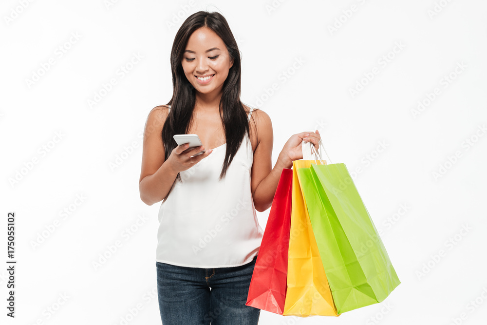 Portrait of a smiling happy asian woman using mobile phone Portrait of a smiling happy asian woman using mobile phone
