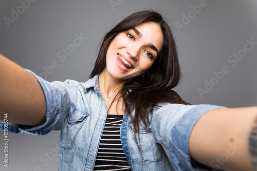 Photography Charming young beautiful woman take selfie from hands on grey