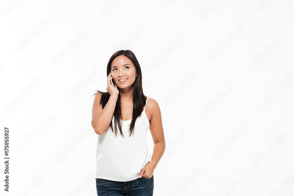 Portrait of a casual asian woman talking on mobile phone Portrait of a casual asian woman talking on mobile phone