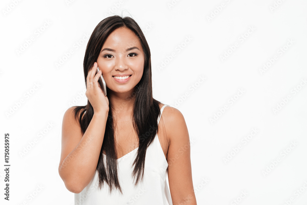 Portrait of a pretty smiling asian woman talking on mobile phone Portrait of a pretty smiling asian woman talking on mobile phone