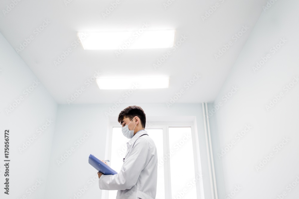 Senior doctor using his tablet computer at work