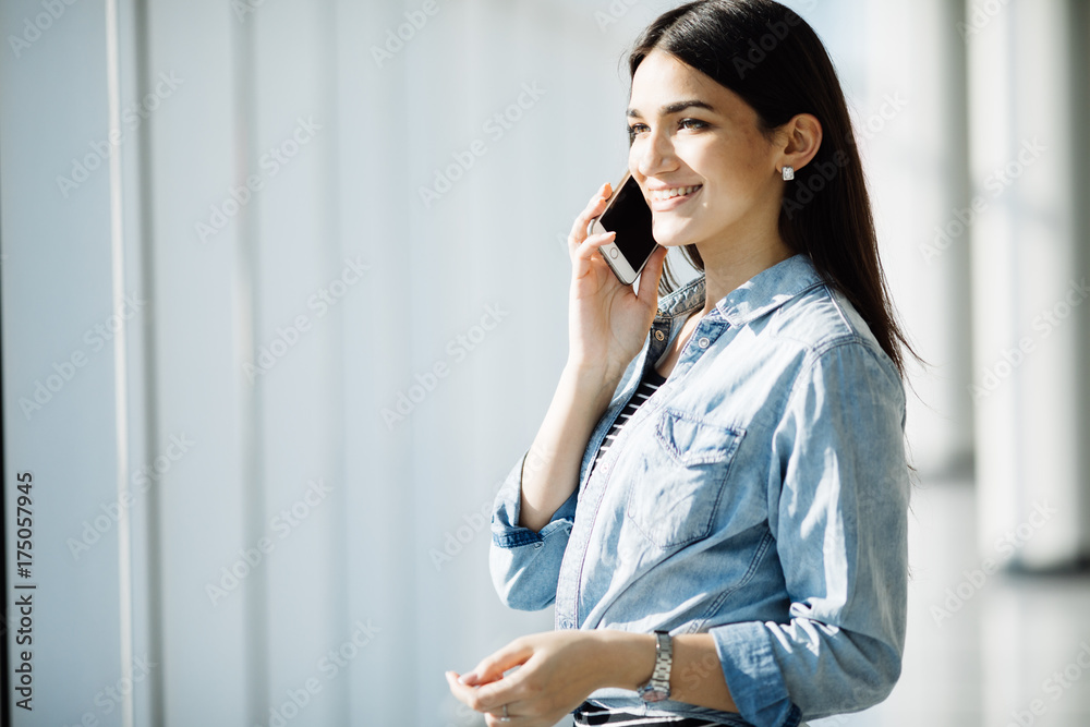 Beauty woman speak phone near panoramic windows. Beauty woman speak phone near panoramic windows.