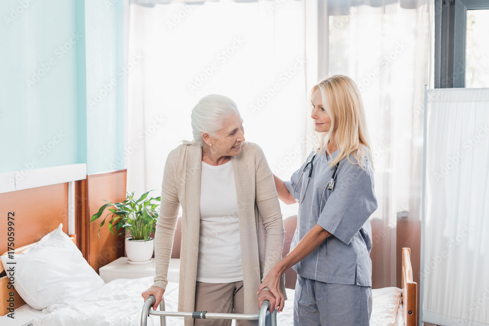 Fototapeta premium nurse and senior patient with walker
