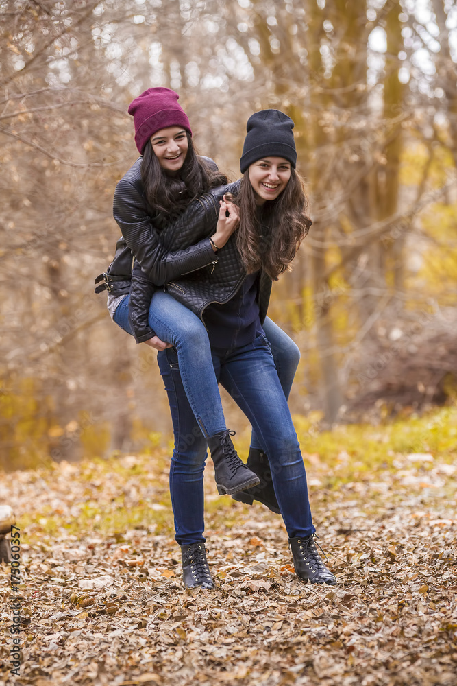 Two girls having fun in autumn park Two girls having fun in autumn park