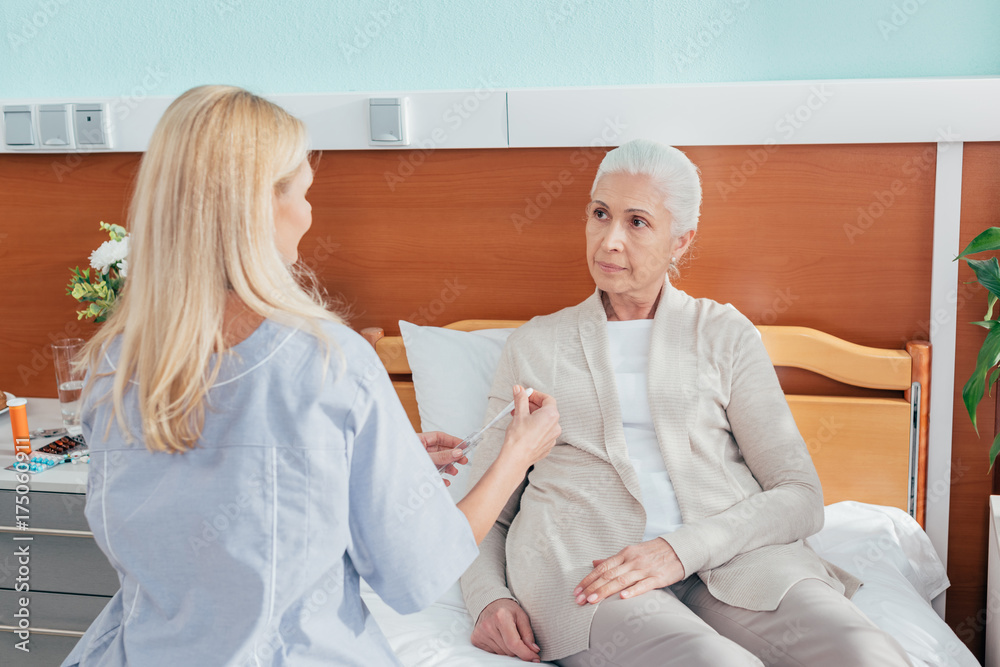 nurse measuring temperature of patient nurse measuring temperature of patient
