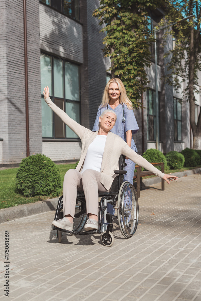 nurse and senior woman in wheelchair nurse and senior woman in wheelchair