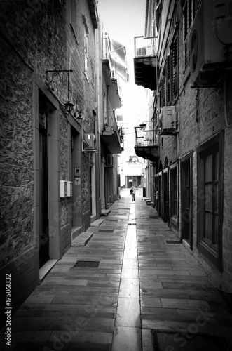 A young woman walking alone at the greek downtown of Naflpion city. Greece