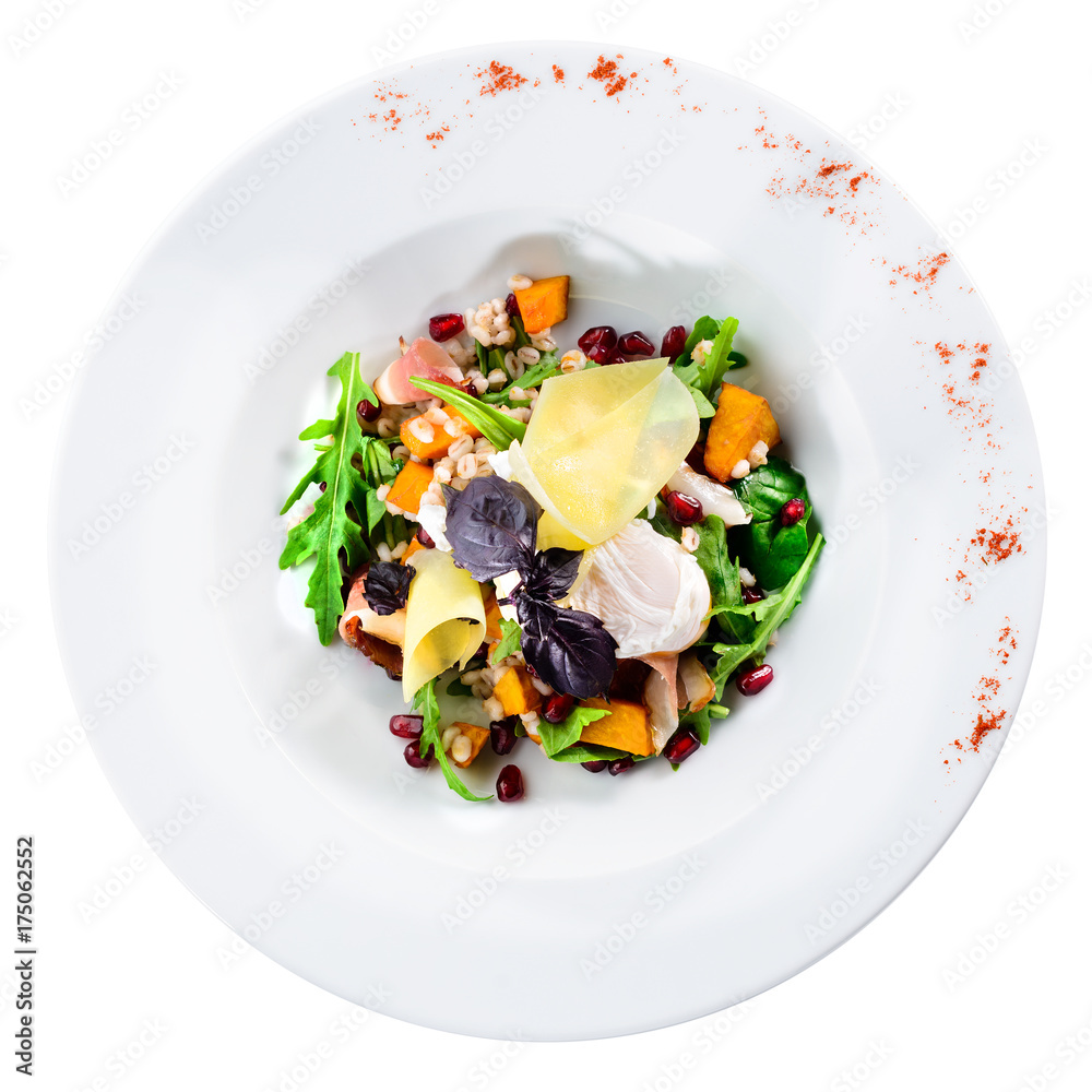 Tasty, delicious salad with baked pumpkin, lettuce and pearl barley in a white plate isolated on white background. Autumn menu in an Italian restaurant, top view, flat, overhead Tasty, delicious salad with baked pumpkin, lettuce and pearl barley in a white plate isolated on white background. Autumn menu in an Italian restaurant, top view, flat, overhead