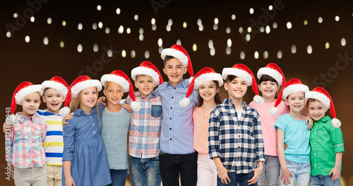 happy smiling children in christmas santa hats