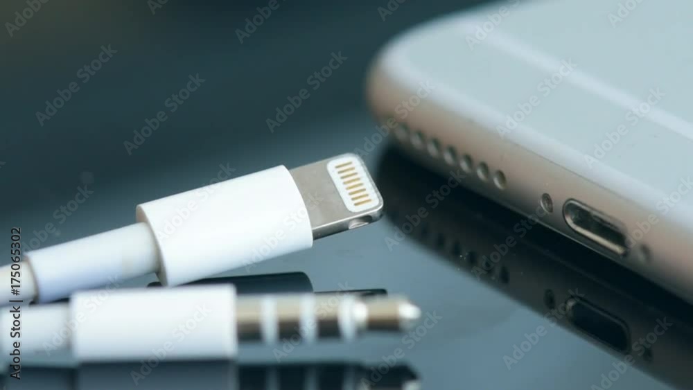 Close up of a mobile phone connected to a charger. Close up of a mobile phone connected to a charger.