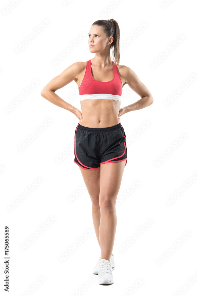 Confident successful fitness female model posing and looking up. Full body length portrait isolated on white studio background. Confident successful fitness female model posing and looking up. Full body length portrait isolated on white studio background.