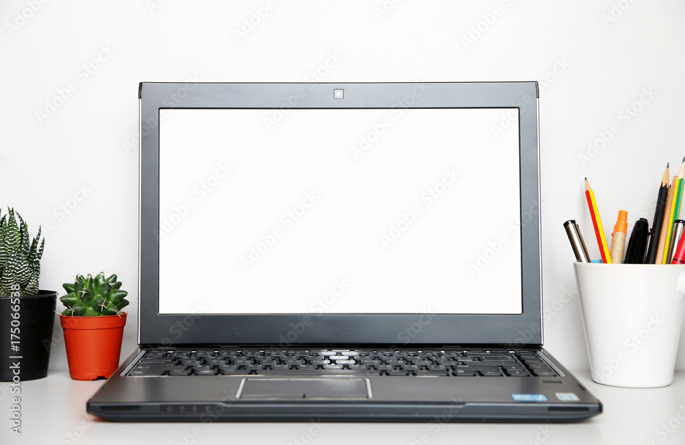 Fototapeta premium studio workplace with blank screen laptop and supplies with copy space for your text.