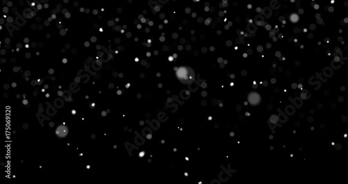 Looping snow flakes falling matte on black background with text space to place logo or copy. Compositable in screen or add blending. Animated abstract overlay. 4k seamless loop video